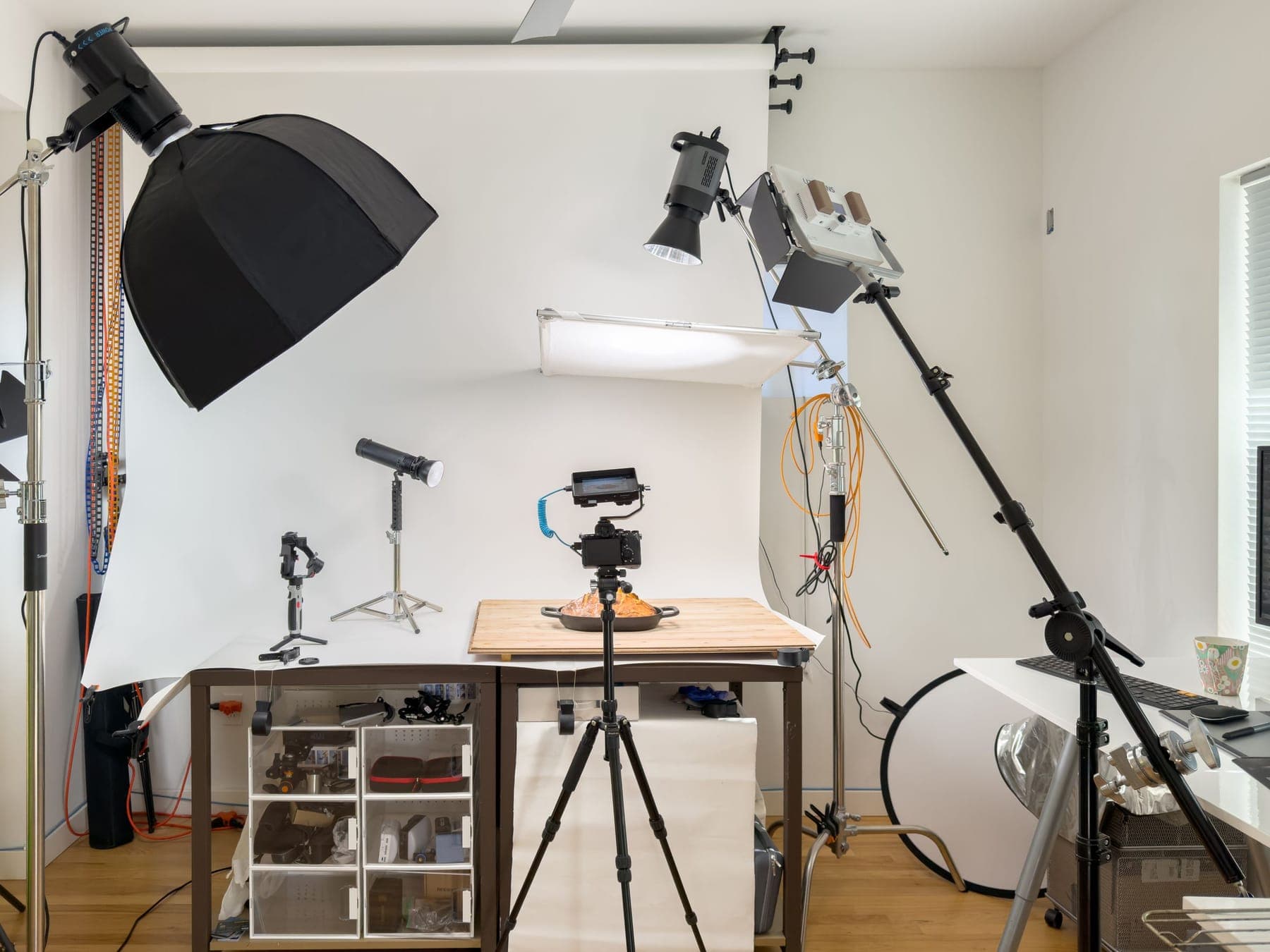 A white studio with lights and a tabletop